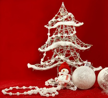 stock photo white christmas tree and decorations with toy snowman at the red background - White Christmas Tree Snowman stock photo white christmas tree and decorations with toy snowman at the red background - White Christmas Tree Snowman