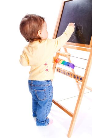 Baby drawing on the blackboard, isolated Stock Photo