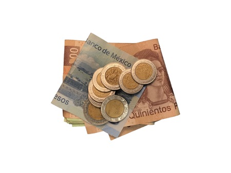 Various mexican coins on top of some peso bills of 20, 100, 200 and 500 folded and grouped isolated on white background