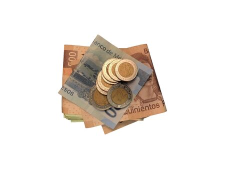 A bunch of mexican coins on top of some peso bills of 20, 100, 200 and 500 folded and grouped isolated on white background