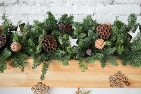 closeup of details of green christmas garland decorated with ratten balls dried flowers of lotus - Green Christmas Garland closeup of details of green christmas garland decorated with ratten balls dried flowers of lotus - Green Christmas Garland