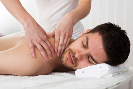 Massage: Человек получает массаж в спа-центре Фото со стока