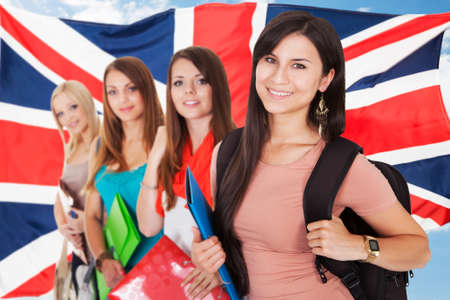 Group Of Happy College Students Standing In Front Of British Flag - 37024069