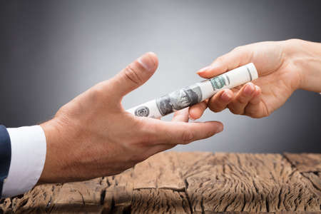 Image result for IMAGE OF SOMEONE GIVING BRIBE