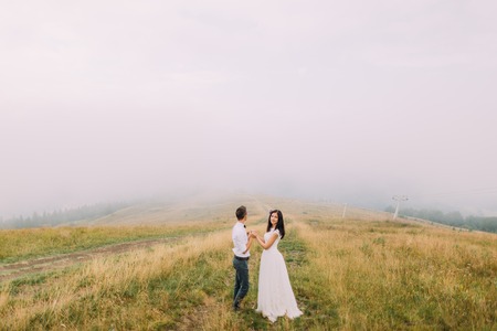 Happy Wedding Couple Holding Hands And Look Into The Distance - 450x300 - jpeg Couple Holding Hands Into The Distance