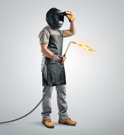 worker welder in a protective mask with gas welding machine on isolated background
