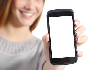 Close up of a funny woman holding a blank smart phone screen isolated on a white background Stock Photo
