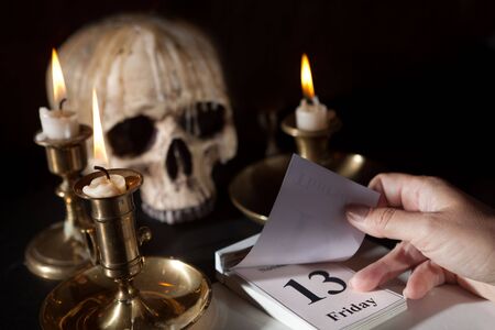 Friday 13th on a calendar with candles and a creepy skull