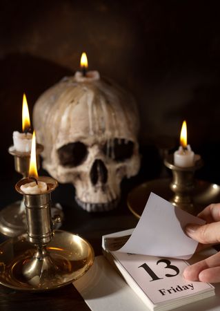Friday 13th on a calendar with candles and a creepy skull