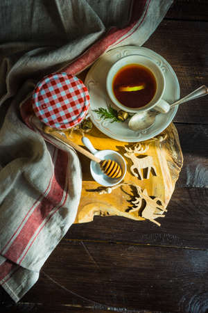 Organic honey and cup of tea for breakfast as a sweet dessert concept