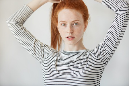 Beautiful Caucasian Young Woman With Healthy Freckled Skin Looking And Smiling With Thoughtful Expression At The Beautiful Caucasian Young Woman With Healthy Freckled Skin Looking And Smiling With Thoughtful Expression At The