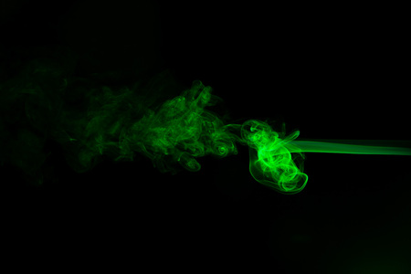 Green coloured smoke abstract lighting on a black background