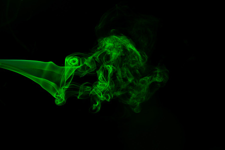 Green coloured smoke abstract lighting on a black background