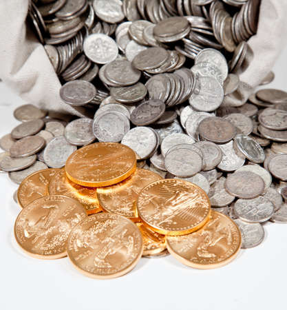 Bag of gold coins: Linen bag of old pure silver coins used to invest in silver as a commodity with a selection of Golden Eagle gold coins