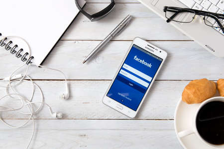 logo samsung: WROCLAW, POLAND- OCTOBER 18th, 2016 : Samsung A5 with Facebook application laying on desk. Facebook is an online social media and social networking service.