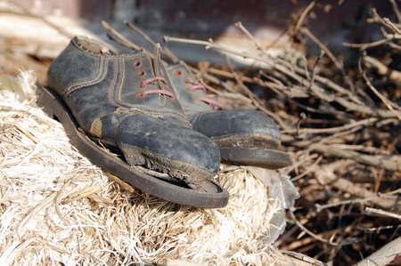 Old decomposing shoes that remind one of the famous actor Charlie Chaplin. Stock Photo