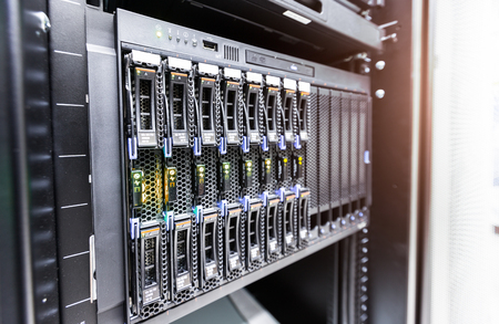 computer server mount on rack in data center room with red lighting