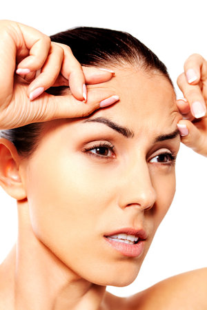 若い女性をクローズ アップ 彼女の額にしわをチェック の写真素材 画像素材 Image