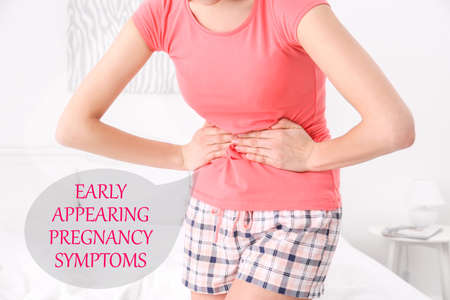 Concept of pregnancy symptoms. Pregnant woman suffering from abdominal pain Stock Photo