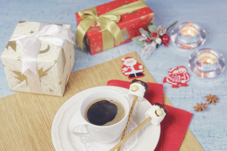 Christmas decoration of breakfast table with coffee cup and handmade marshmallow candies deers