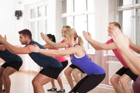 Group of people strengthening bottom muscles during fitness classes