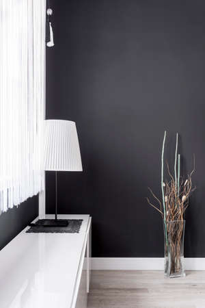 Simple lamp with white lampshade in black room - 84519772