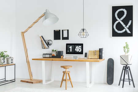 white minimalist studio with wooden desk space and accessories stock
