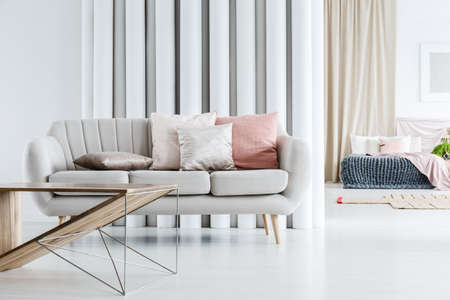 Decorative Pillow On Grey Sofa And Designer Table In Bright Living Simple Bright Living Room Decoration Decorative Pillow On Grey Sofa And Designer Table In Bright Living Simple Bright Living Room Decoration