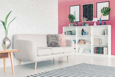White Sofa In Pink Living Room Interior With White Brick Wall