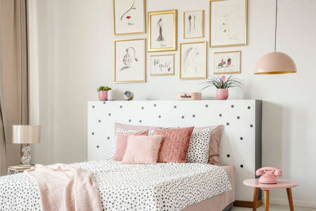 beautiful white bedroom interior with feminine decor, polka dot..