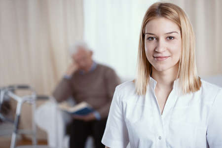 Beautiful young nurse with blonde hair and white uniform Фото со стока