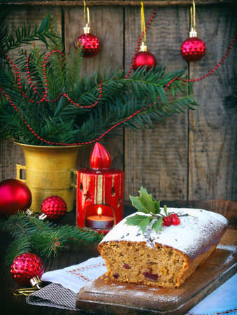 stock photo traditional christmas fruit cake decorated with powdered sugar and xmas decorations candle copy space style rustic - Christmas Fruit Cake Decoration stock photo traditional christmas fruit cake decorated with powdered sugar and xmas decorations candle copy space style rustic - Christmas Fruit Cake Decoration