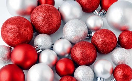 Christmas tree toys on a white background christmas decorations on a white surface balls and garland of red and silver colors on the table