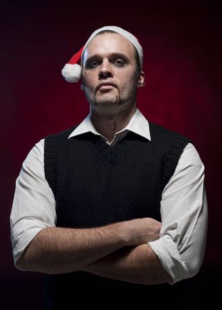 an evil christmas elf portrait with makeup and blood splash on his face stock photo - Christmas Elf Makeup an evil christmas elf portrait with makeup and blood splash on his face stock photo - Christmas Elf Makeup