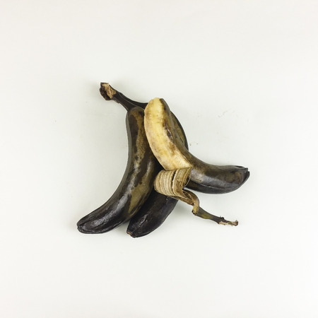 Black and yellow rotten banana isolated on white background - top view