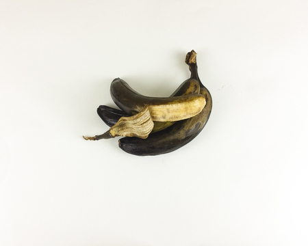 Black and yellow rotten banana isolated on white background - top view