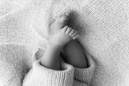 Closeup of a newborn baby feet with beautiful selective focus concept for maternity and tenderness Stock Photo