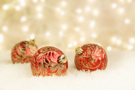 red and gold christmas ornaments on white rug with gold background and lights stock photo - Red And Gold Christmas Ornaments red and gold christmas ornaments on white rug with gold background and lights stock photo - Red And Gold Christmas Ornaments
