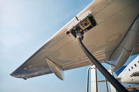 Ground service before flight. refueling of airplane at airport. Banco de Imagens