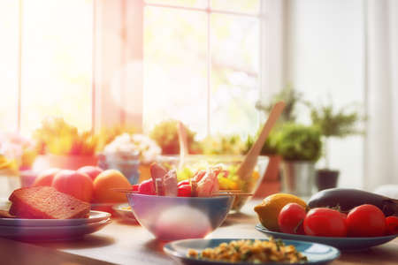 balanced diet, cooking, culinary and food concept. food for a family dinner on a wooden table in the dining room. Stock Photo