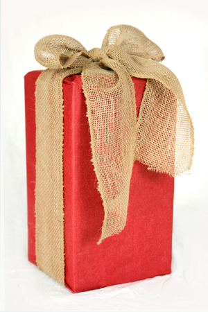 a big rectangular shaped christmas gift box is wrapped in red paper and a burlap ribbon - Christmas Burlap Ribbon a big rectangular shaped christmas gift box is wrapped in red paper and a burlap ribbon - Christmas Burlap Ribbon