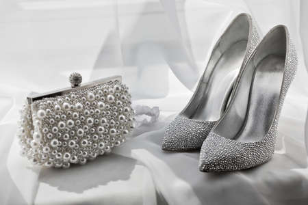 silver sandals and clutch bag
