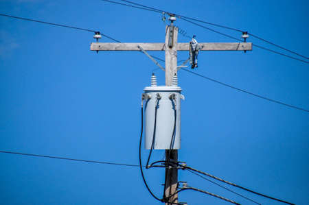 energy and technology electrical post by the road with power
