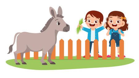 Happy cute little kid boy and girl feed donkey