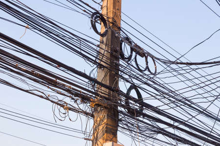 messy electrical post with lots of cables and wires often seen