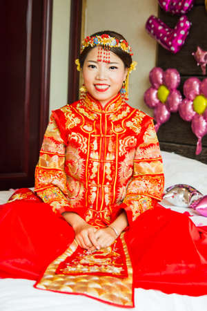 chinese bride in traditional red wedding dress portrait stock photo