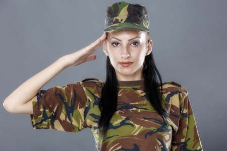 Woman Army Soldier Saluting Isolated On Gray Background Photo Woman Army Soldier Saluting Isolated On Gray Background Photo