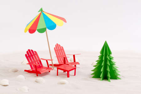 made from paper christmas tree beach chair and umbrella in the sand white background - Umbrella Christmas Tree made from paper christmas tree beach chair and umbrella in the sand white background - Umbrella Christmas Tree