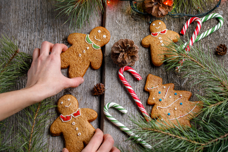 a girl is decorating a table for christmas gingerbread men ginger biscuits and lollipops - Christmas Gingerbread Men Decorations a girl is decorating a table for christmas gingerbread men ginger biscuits and lollipops - Christmas Gingerbread Men Decorations