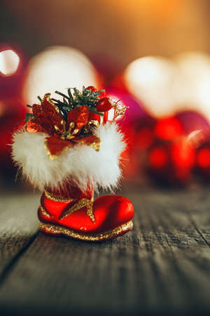 red christmas boo on rustic wooden board soft bokeh lights and christmas boo